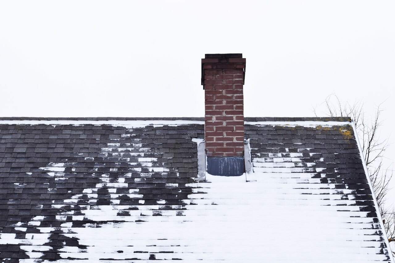 freeze thaw deteriorating the shingles and flashing on a roof not properly weatherproofed
